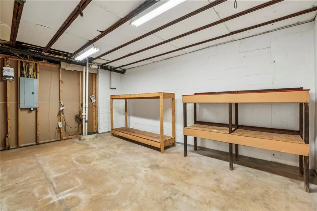 Extra storage room with built in storage racks. There is also a second storage area for mechanicals and includes a work bench.