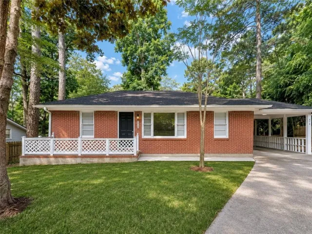 Brick exterior with a dark roof and white trim