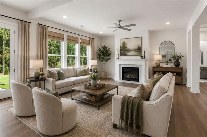 The great room seamlessly opens to the dining area and kitchen, creating an inviting open-concept layout, and is anchored by a beautiful fireplace with a marble surround. *All photos are representative of a Chatham floorplan.