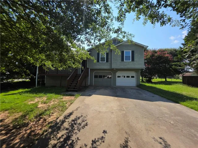 Two-story exterior with light green siding and dark shutters