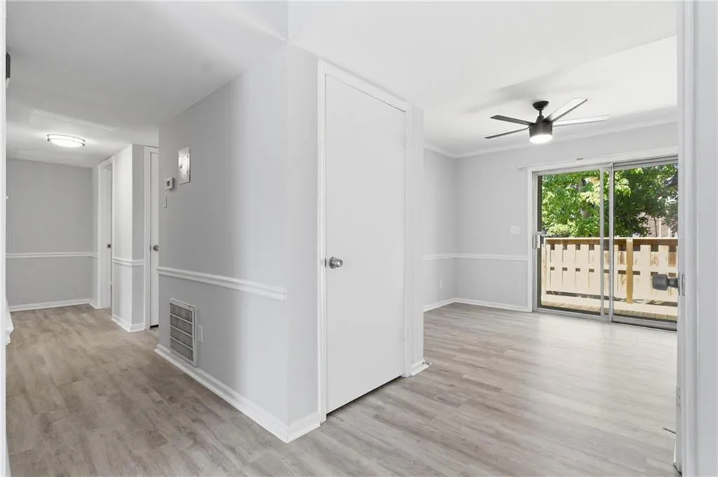 Hallway featuring light wood-style flooring and crown molding