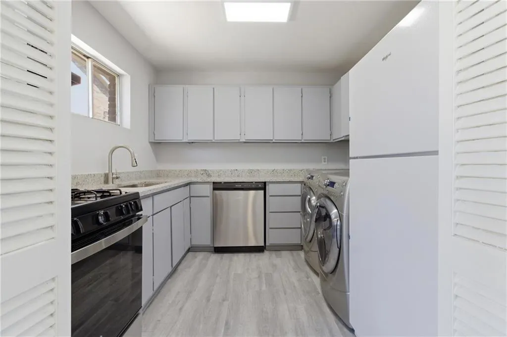 Laundry area featuring light wood-type flooring