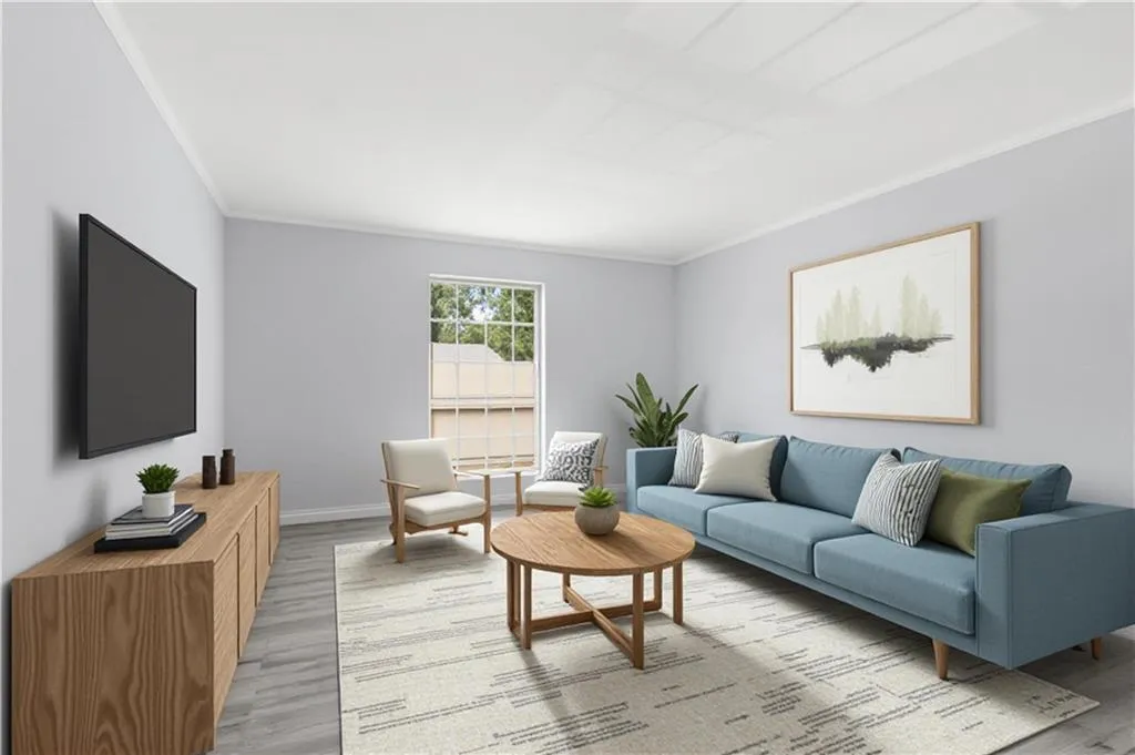 Living area featuring crown molding and light wood-type flooring