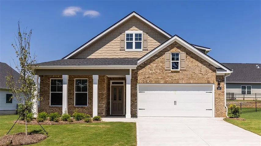 Brick and siding exterior with a dark-shingle roof