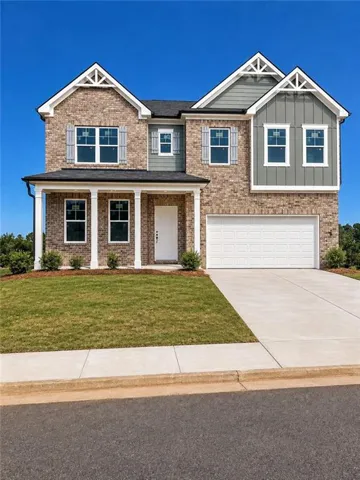 Brick and siding exterior with decorative gable vents, covered front porch with columns, and an integrated two-car garage