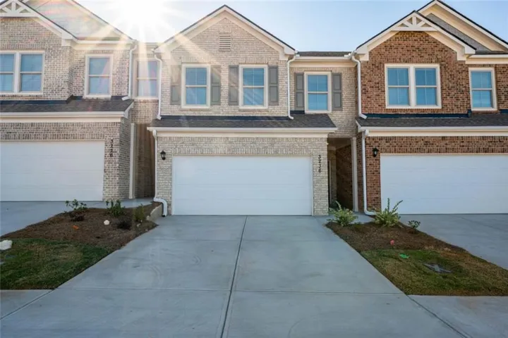 Townhome / multi-family property featuring a garage