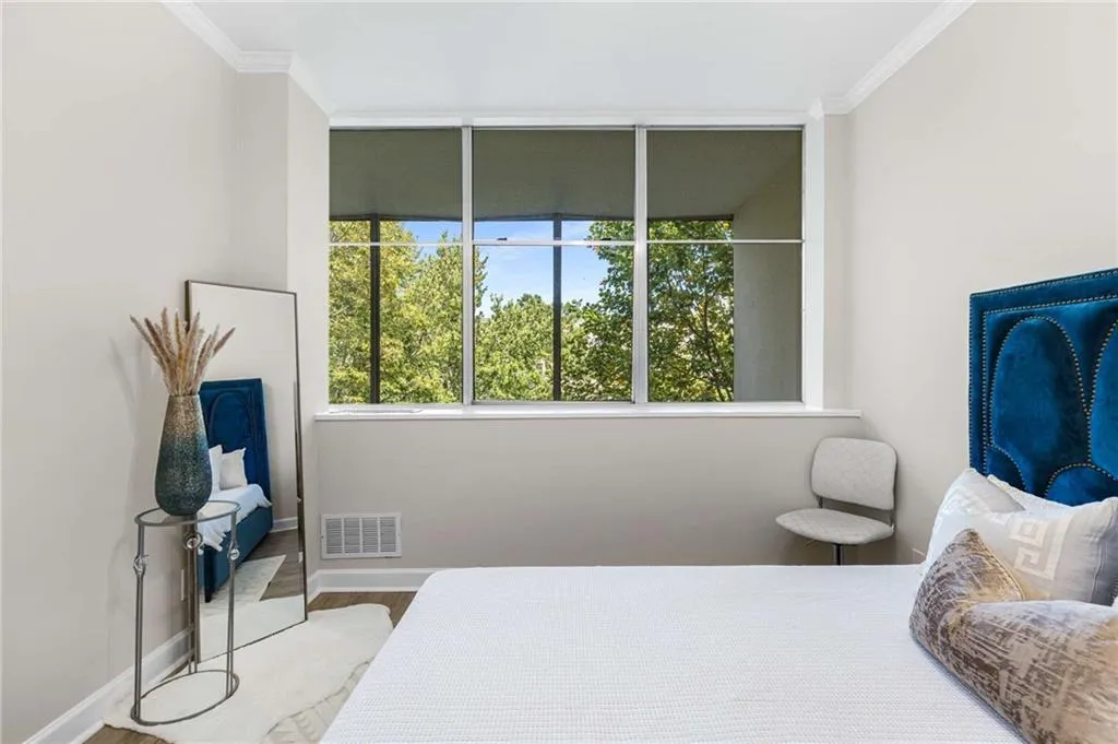 Bedroom featuring crown molding and wood finished floors