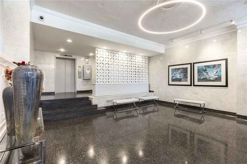 Building lobby with ornamental molding and a textured ceiling