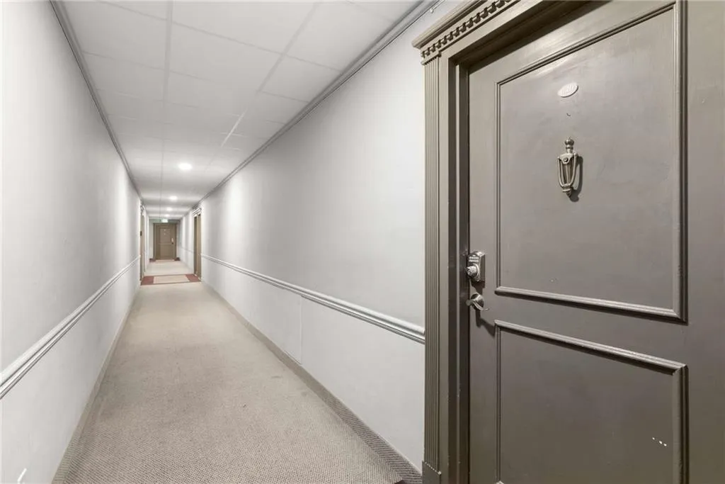 Corridor featuring carpet and a drop ceiling