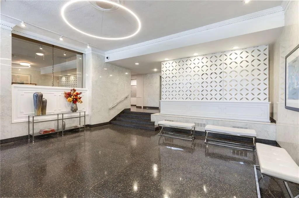 Building lobby with ornamental molding and stairway