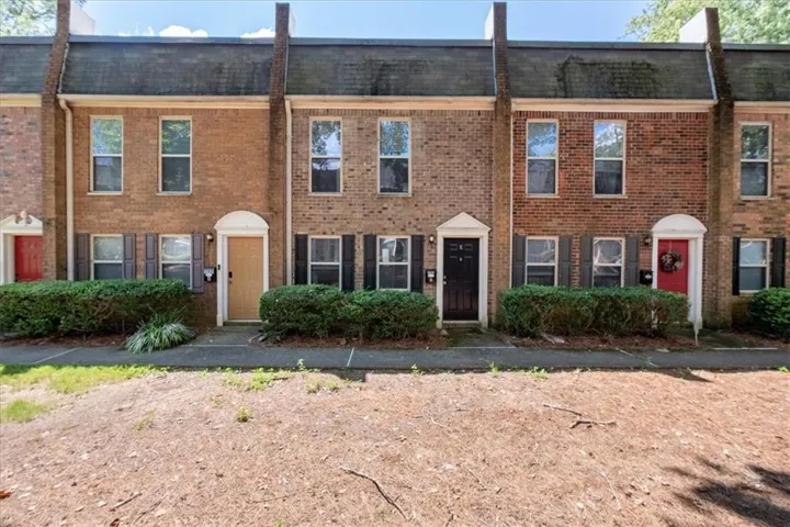 Brick exterior, traditional shutters, and established landscaping