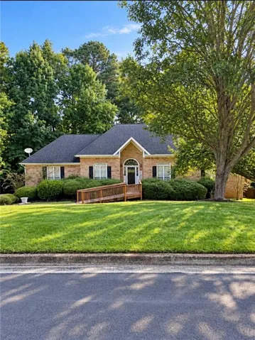 Brick exterior with dark roof and gabled entry