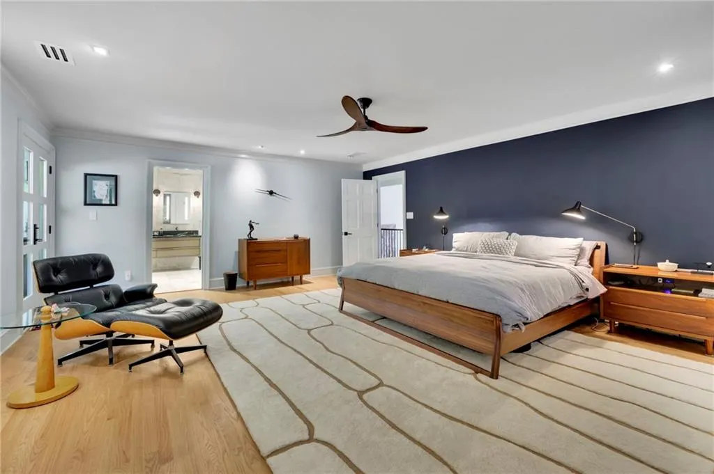 Bedroom with wood finished floors, a ceiling fan, recessed lighting, and crown molding