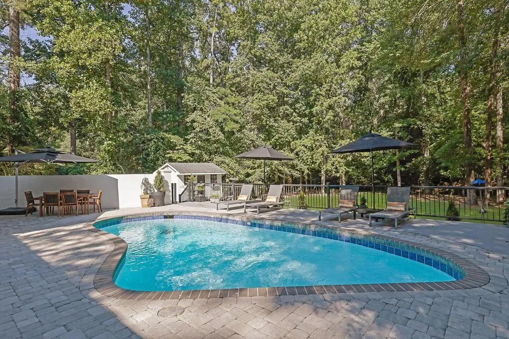 View of swimming pool featuring a patio area and an outdoor structure