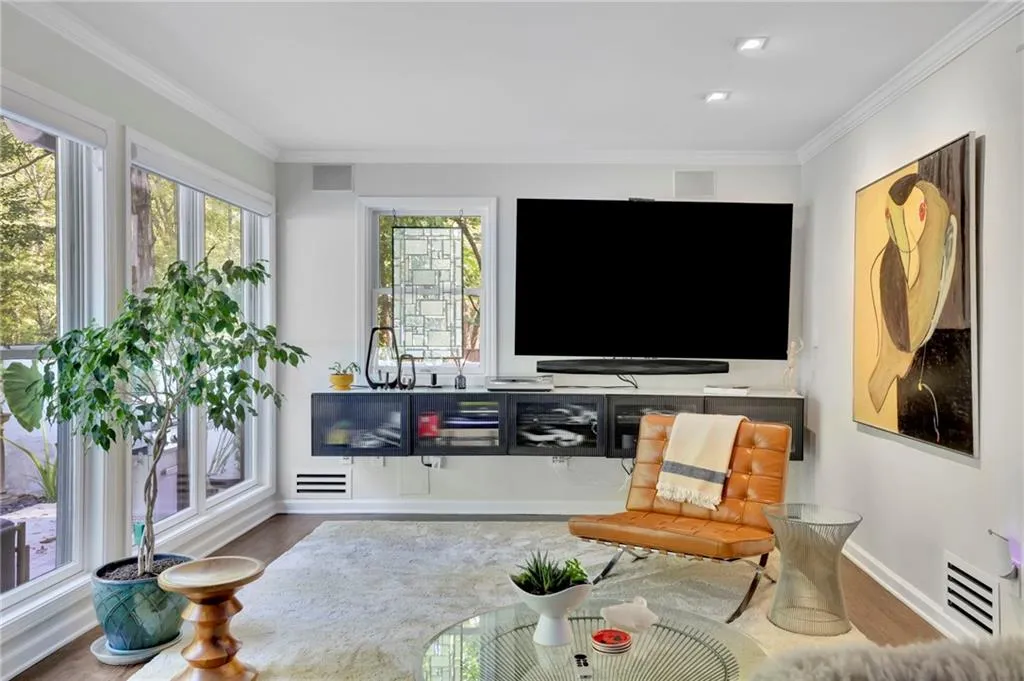 Living area featuring crown molding and wood finished floors