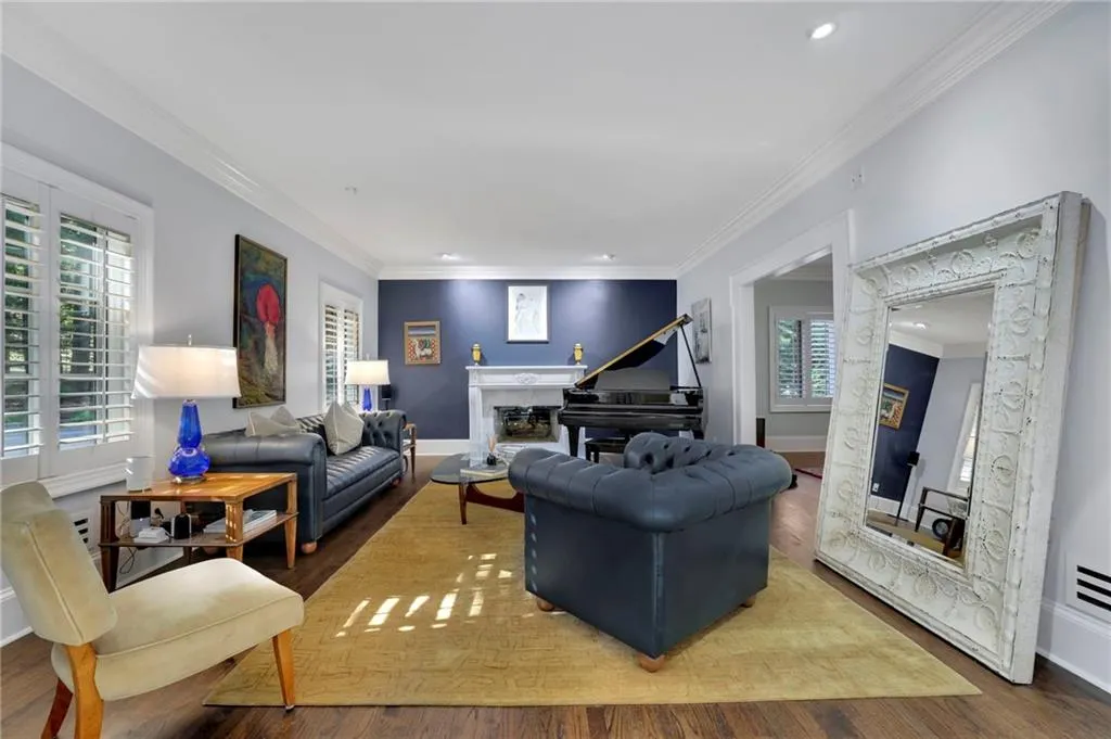 Office area with ornamental molding, dark wood-type flooring, a glass covered fireplace, and recessed lighting