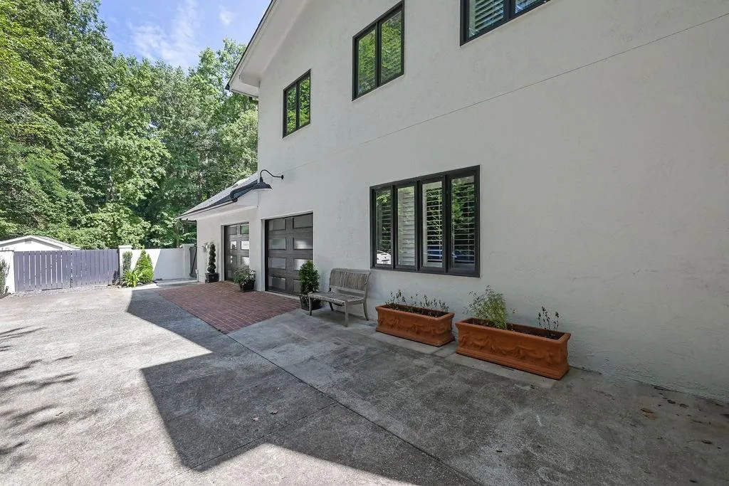 Back of property with stucco siding and a patio
