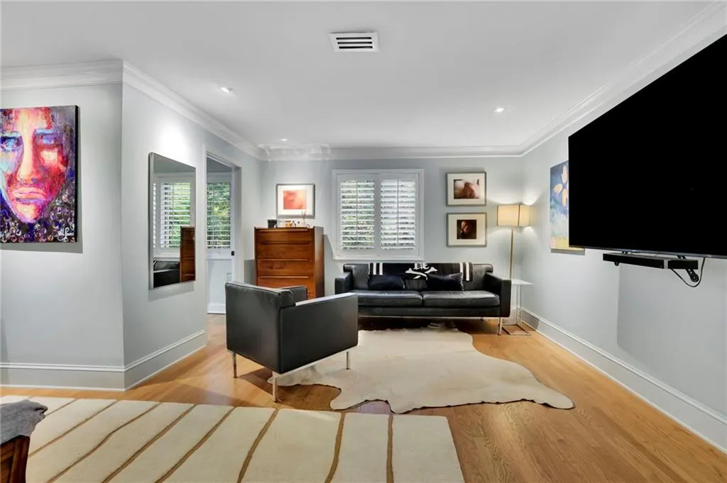 Living room with light wood-type flooring, healthy amount of natural light, crown molding, and recessed lighting