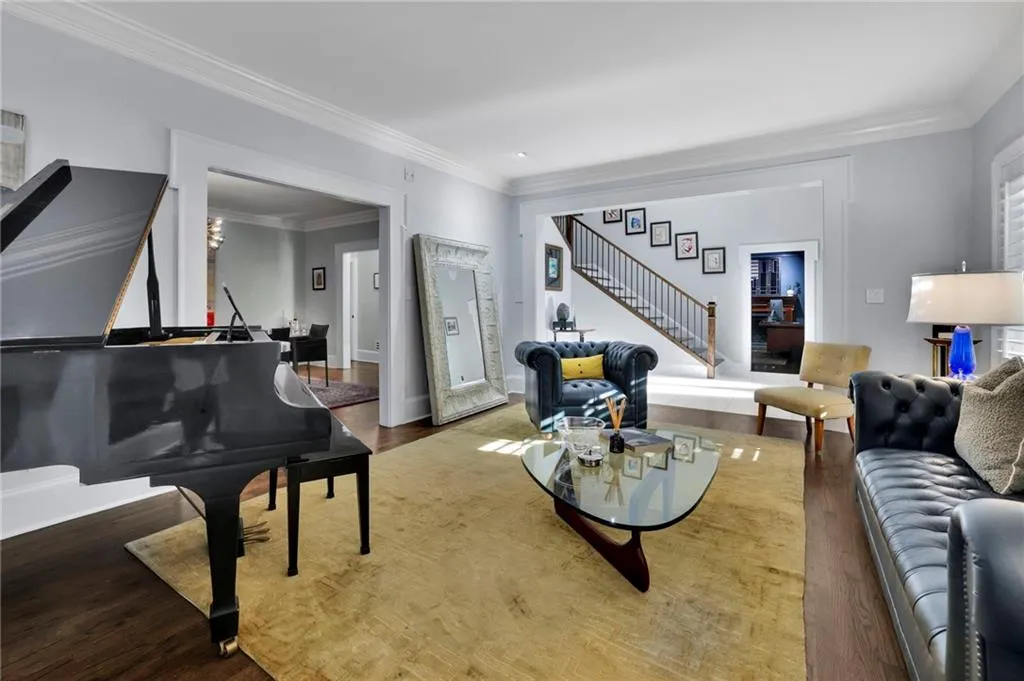 Living area featuring ornamental molding and wood finished floors