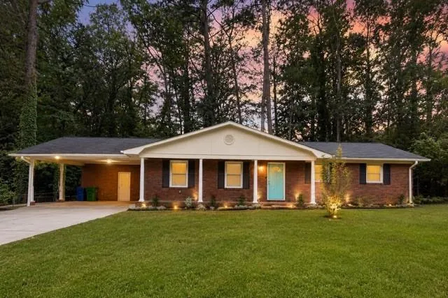 Brick exterior with a covered carport