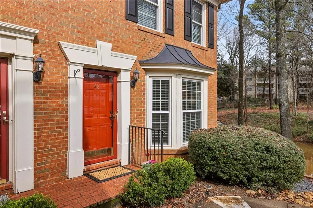 Entrance to property featuring brick siding