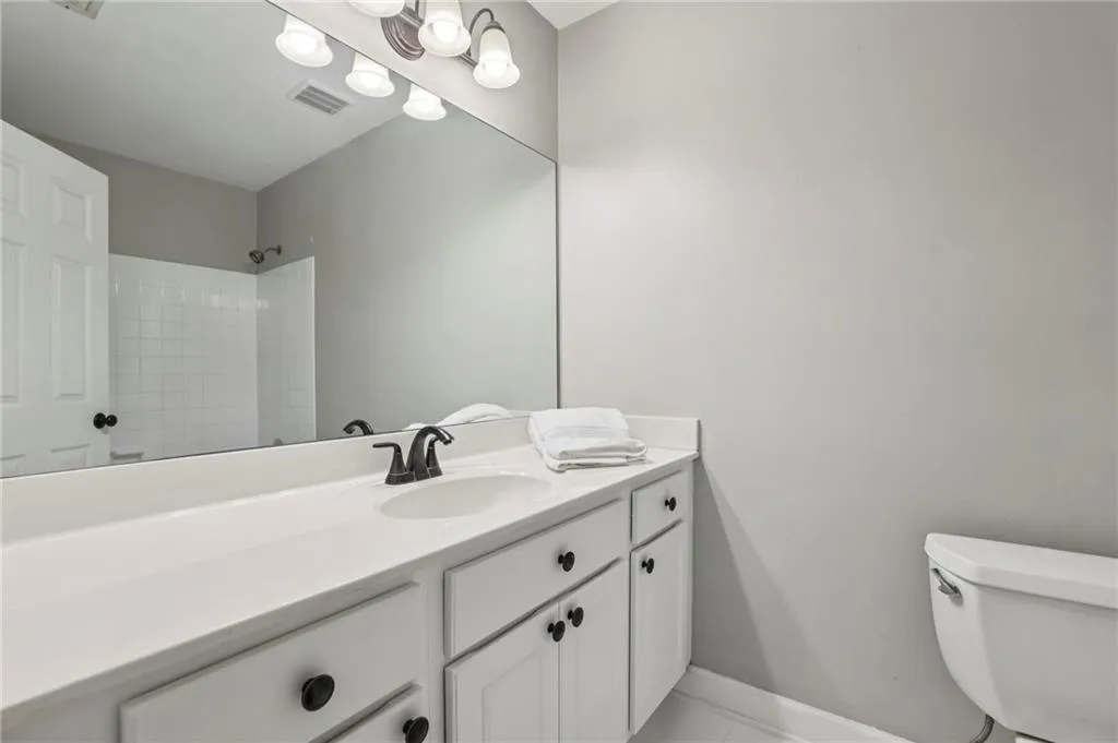 Bathroom with vanity and a shower