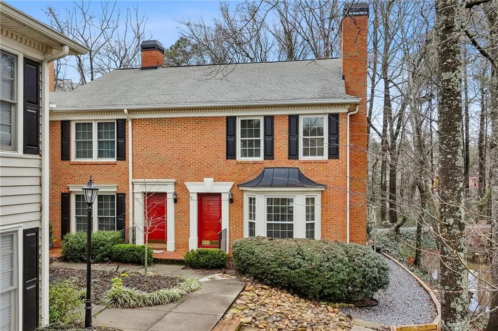 Colonial house with a chimney and brick siding