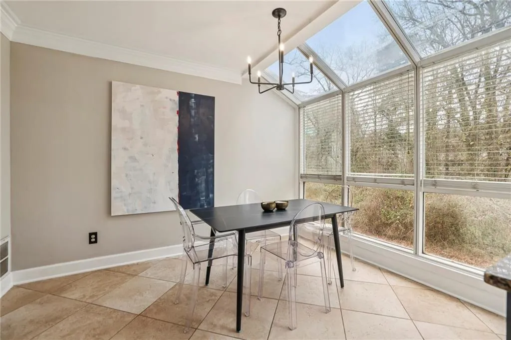 Dining room featuring crown molding and a chandelier