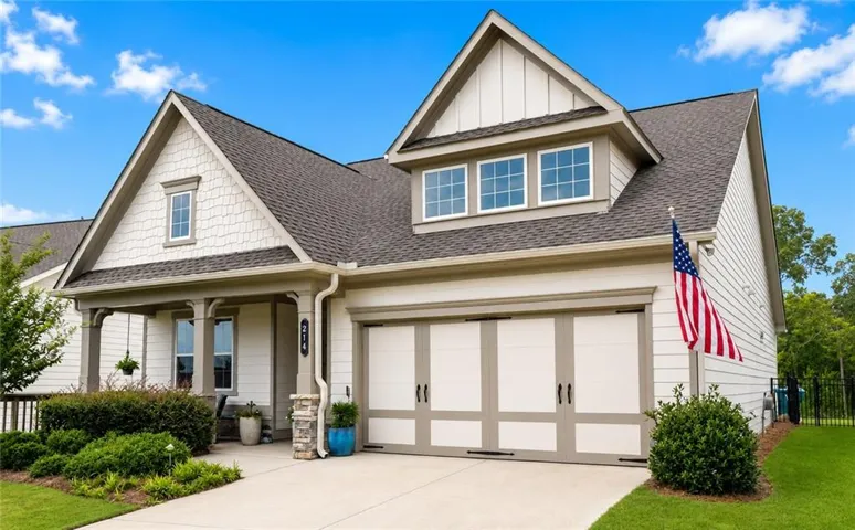 Craftsman-style exterior with a covered front porch featuring stone column bases