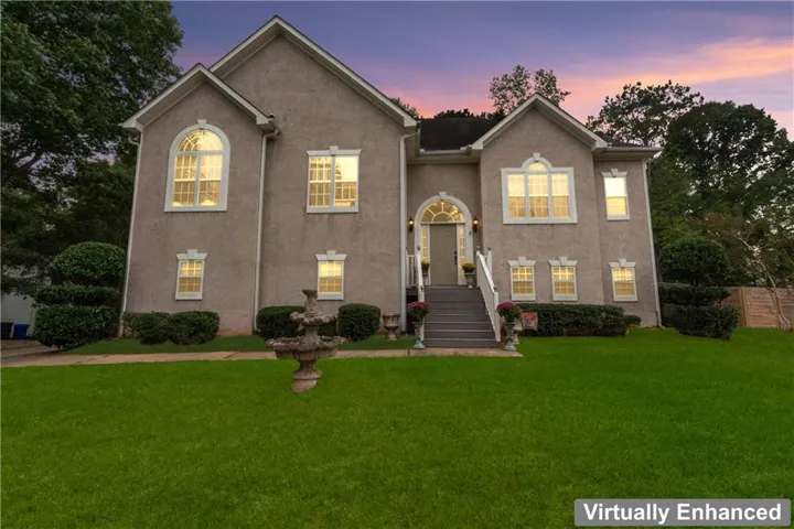 Stucco exterior with multiple gables and arched window details