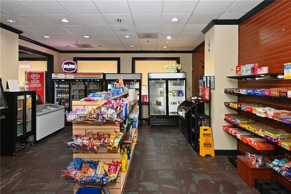 Rec room featuring crown molding and dark tile flooring