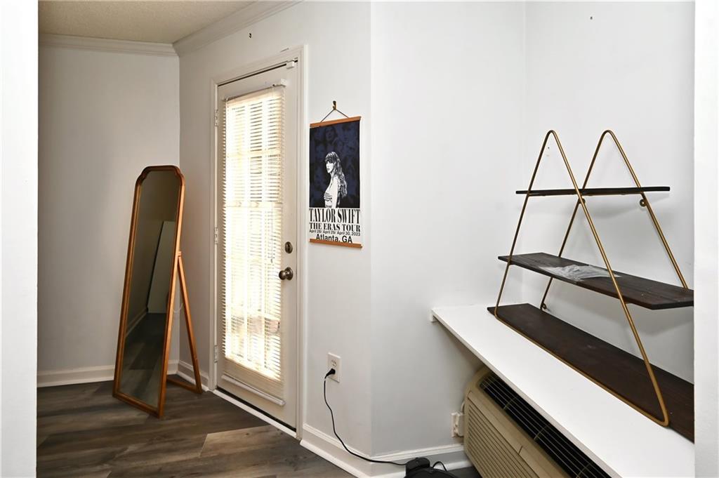 Entryway featuring crown molding and dark hardwood / wood-style floors