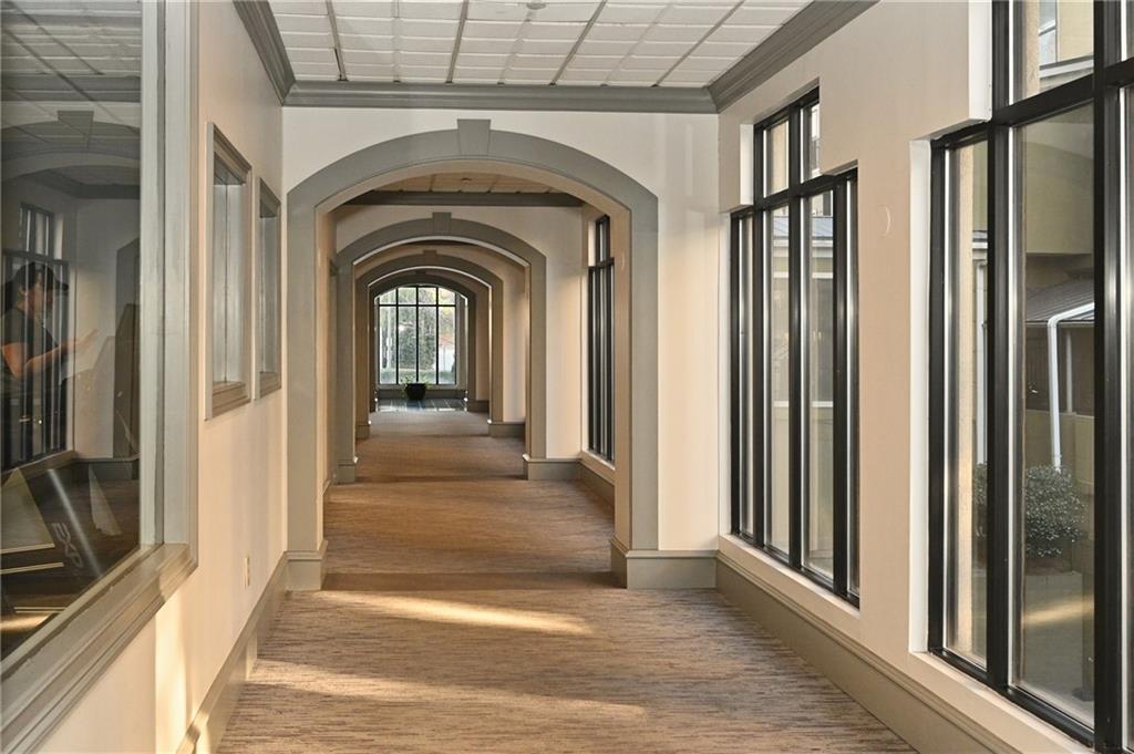 Hallway featuring dark hardwood / wood-style floors and ornamental molding