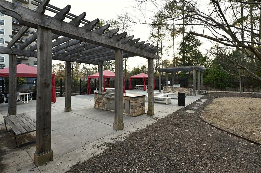 Surrounding community with a gazebo, exterior kitchen, and a pergola