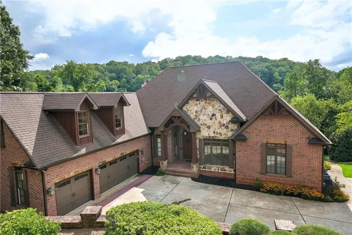 Brick and stone exterior with a multi-gabled roof and dormer windows