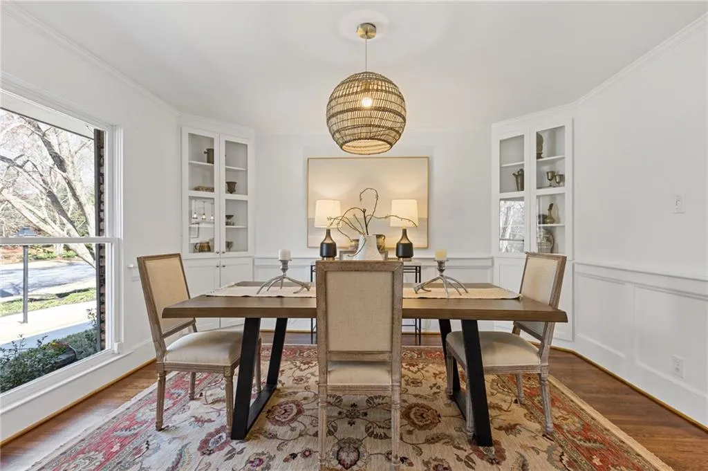 Dining area featuring built in shelves, wood finished floors, and a wealth of natural light