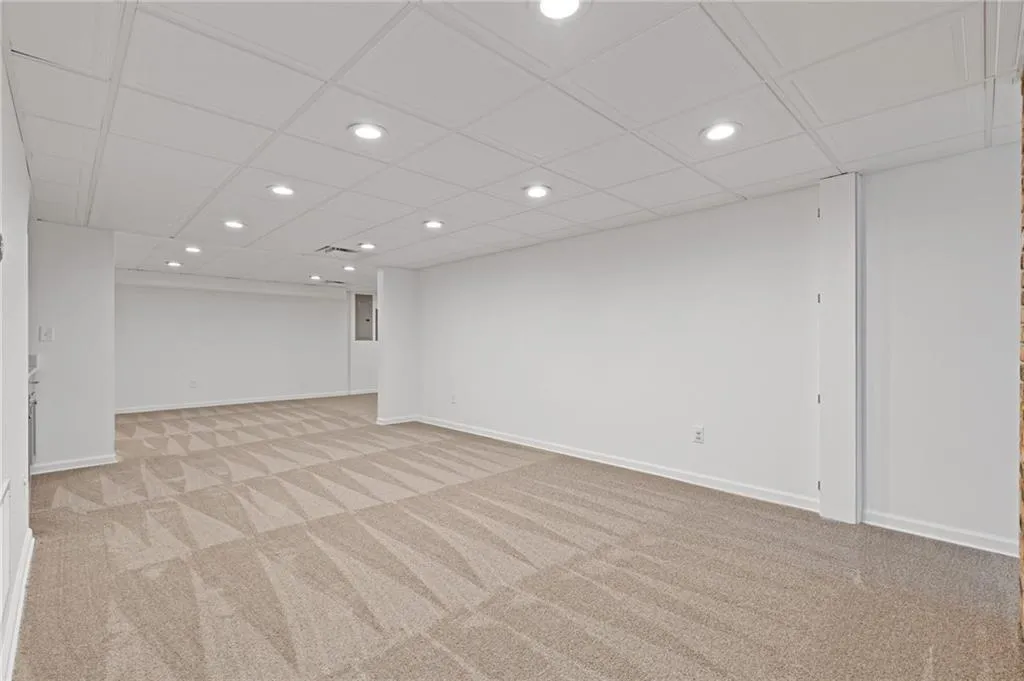 Empty room with recessed lighting, light colored carpet, and baseboards