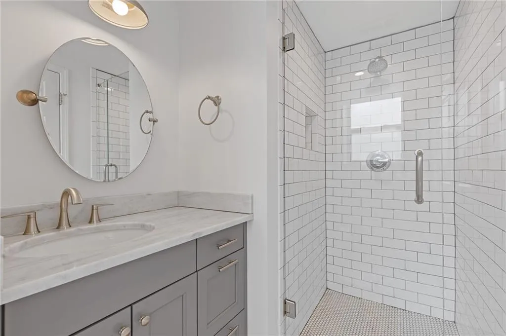 Bathroom with a stall shower and vanity