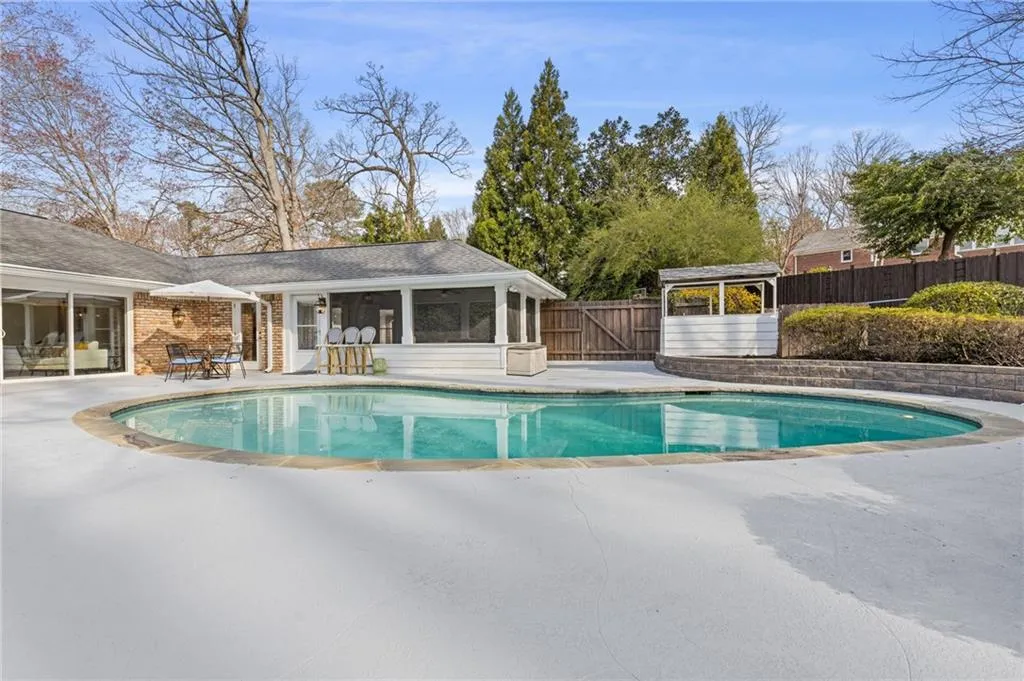 View of pool featuring a patio area, a sunroom, a fenced in pool, and fence