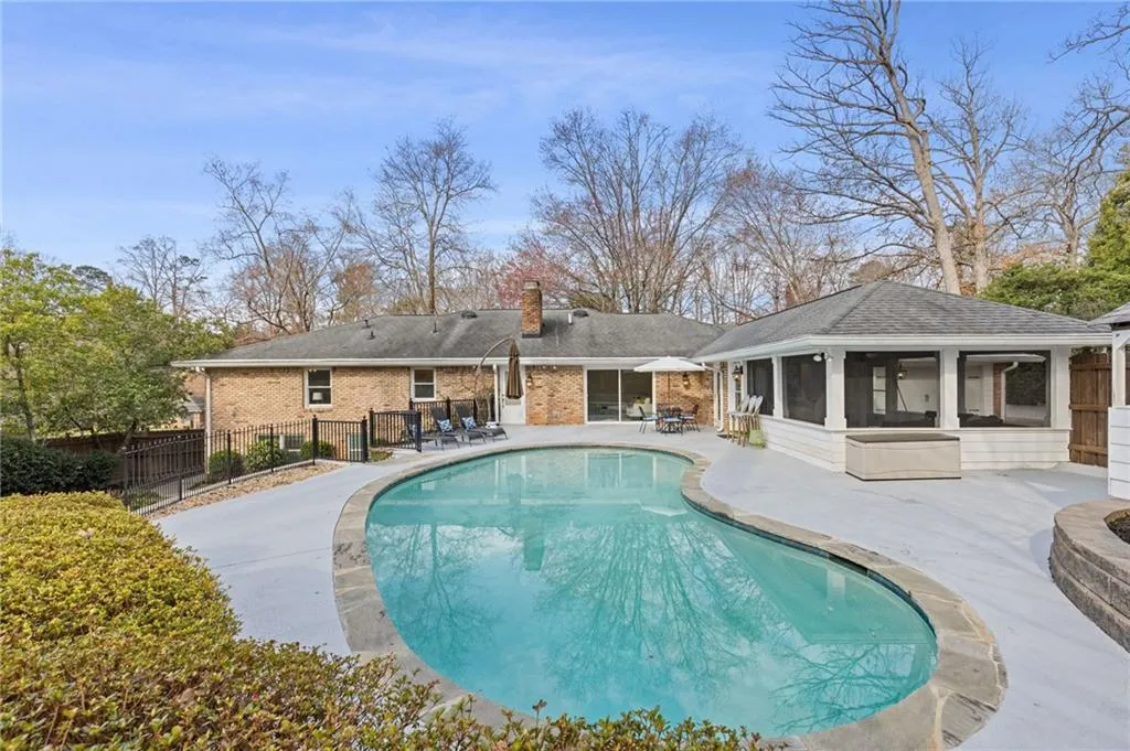 View of swimming pool with a fenced in pool, a patio, fence, and a sunroom