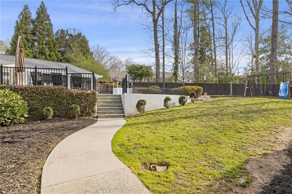 View of yard with stairway, fence private yard, and a playground