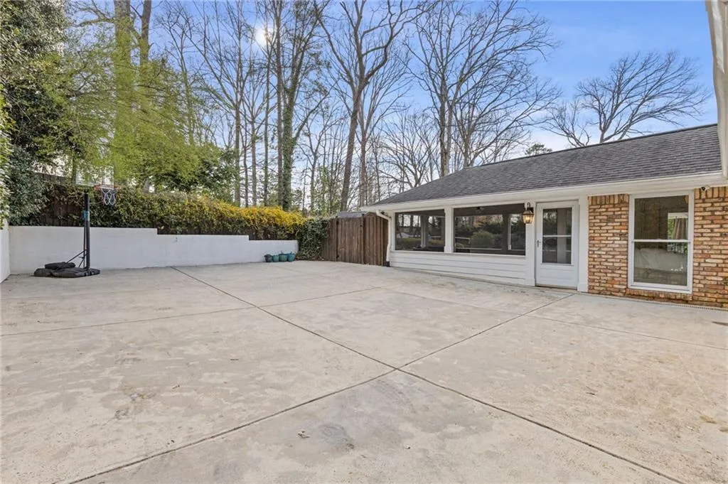View of patio featuring fence