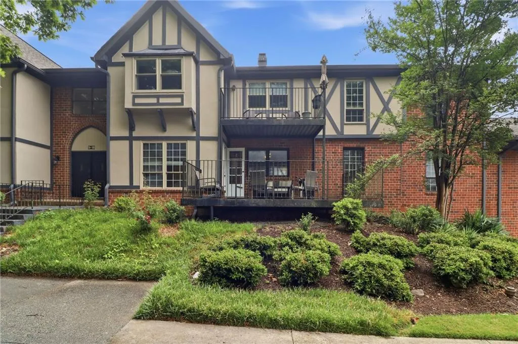 Tudor-style exterior featuring a prominent bay window and brick accents