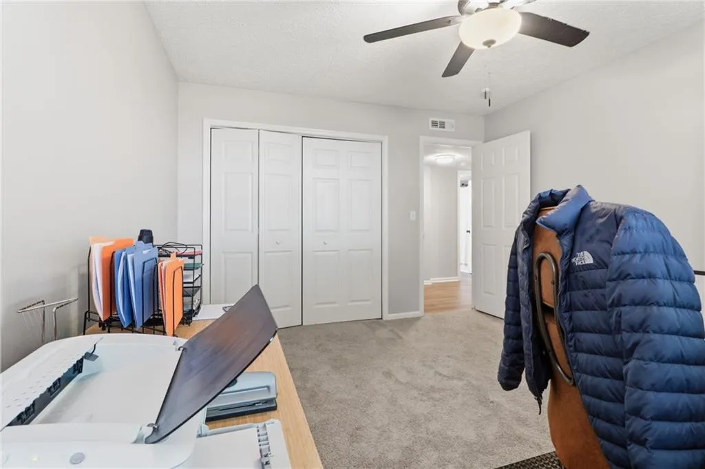 Neutral wall color with recessed lighting, ceiling fan, and carpeted flooring