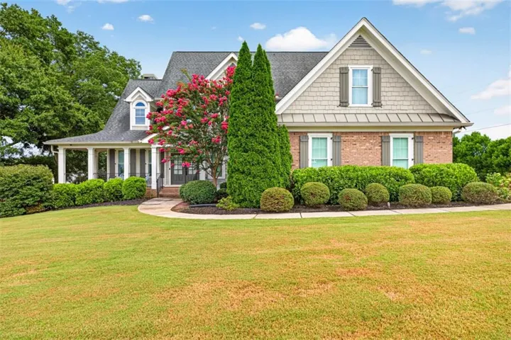 Brick and shake siding exterior with a covered porch