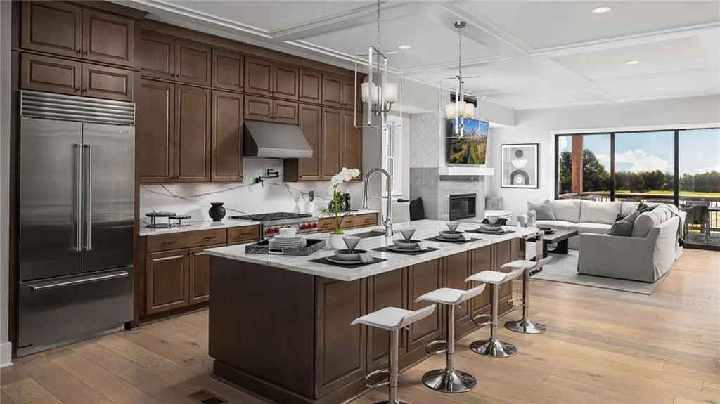 Accompanied by plenty of cabinet and counter space, and a massive center island, this state-of-the-art kitchen is truly the centerpiece of the home. THIS PHOTO IS OUR MODEL HOME  AT HIGHLANDS AT VININGS.