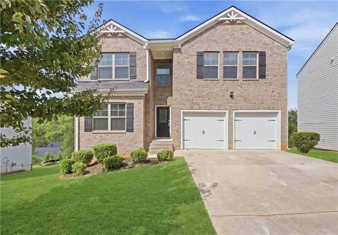 Brick exterior, two-story construction, two-car garage, concrete driveway, and front landscaping