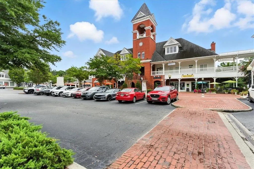 View of property featuring uncovered parking
