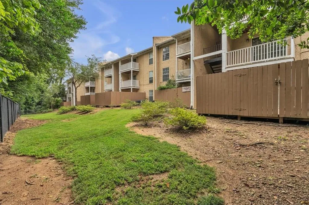 View of yard featuring a balcony