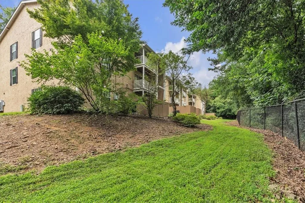 View of yard with a balcony